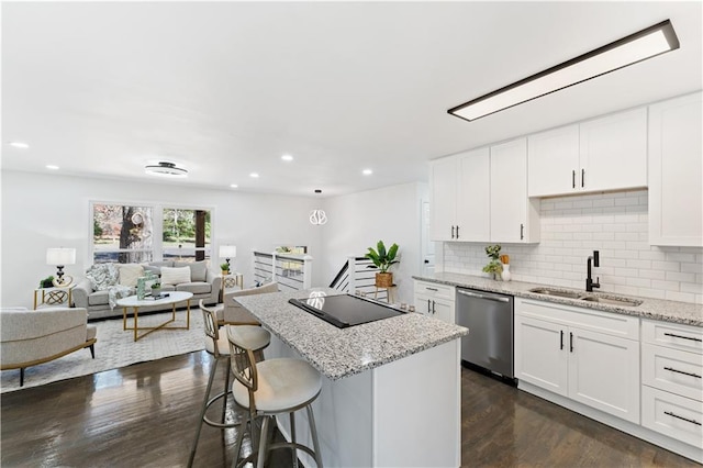 kitchen featuring black electric cooktop, white cabinetry, stainless steel dishwasher, and sink