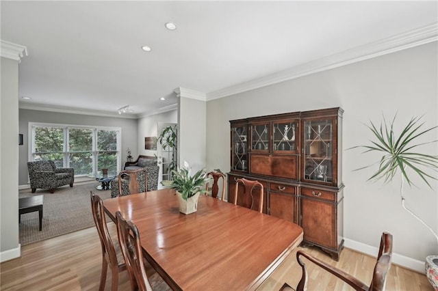 dining area featuring ornamental molding, baseboards, recessed lighting, and light wood finished floors