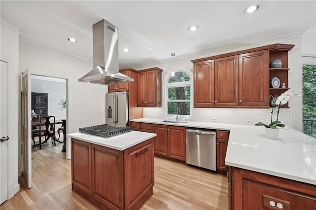 kitchen featuring stainless steel appliances, island range hood, a sink, ornamental molding, and tasteful backsplash