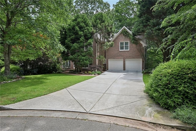 view of front of house with a garage, concrete driveway, and a front yard