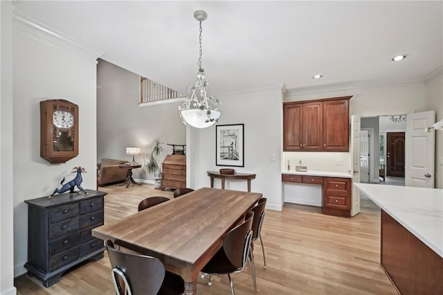 dining room with light wood finished floors, a chandelier, crown molding, baseboards, and recessed lighting