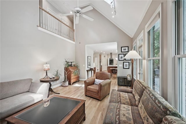 living room featuring light wood finished floors, ceiling fan, and high vaulted ceiling