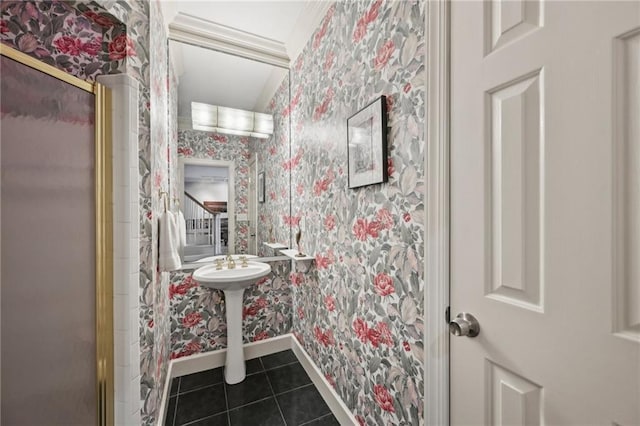 bathroom with wallpapered walls, baseboards, tile patterned flooring, and an enclosed shower