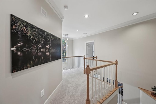 corridor with an upstairs landing, crown molding, recessed lighting, carpet flooring, and baseboards