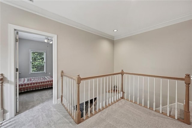 hall featuring carpet floors, crown molding, an upstairs landing, and recessed lighting