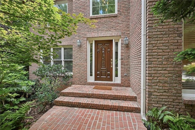 property entrance with brick siding