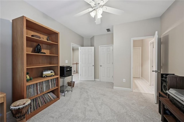 living area with a ceiling fan, carpet flooring, and baseboards