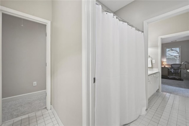 bathroom featuring tile patterned flooring, vanity, and baseboards