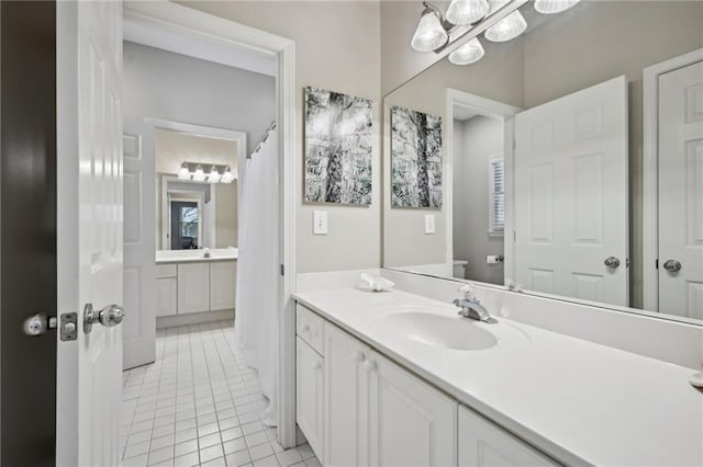 bathroom with tile patterned flooring, vanity, toilet, and healthy amount of natural light