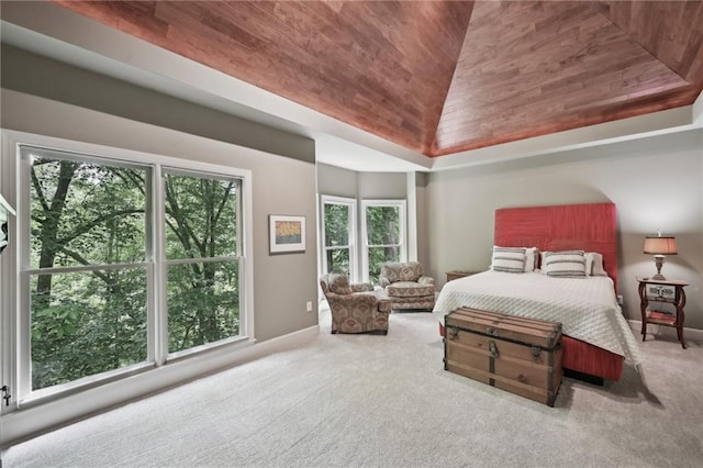 bedroom featuring wood ceiling, multiple windows, carpet flooring, vaulted ceiling, and baseboards