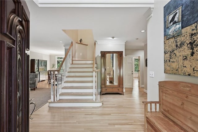 entryway featuring crown molding, stairway, wood finished floors, recessed lighting, and baseboards