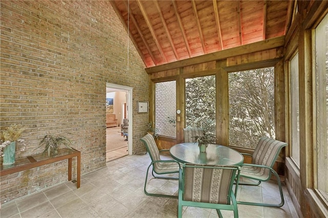 sunroom / solarium featuring vaulted ceiling