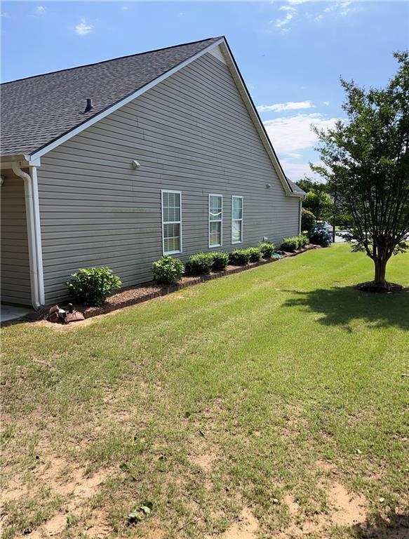 964 Village View Cir, Loganville, GA 30052 - view of side of home with a yard and a shingled roof