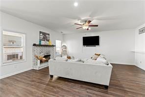 6547 River Station Dr, Lula, GA 30554 - living area with ceiling fan, a fireplace, dark wood-style floors, and baseboards