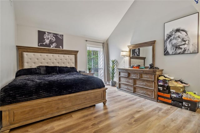 bedroom featuring vaulted ceiling and hardwood / wood-style flooring