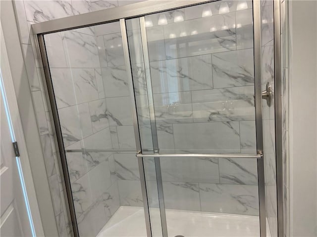 full bathroom featuring a marble finish shower