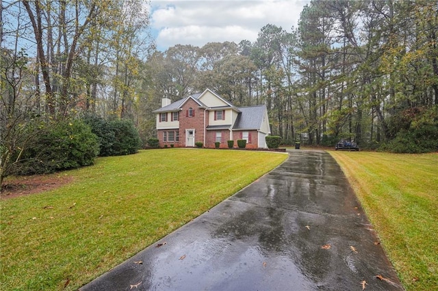 raised ranch with a front lawn