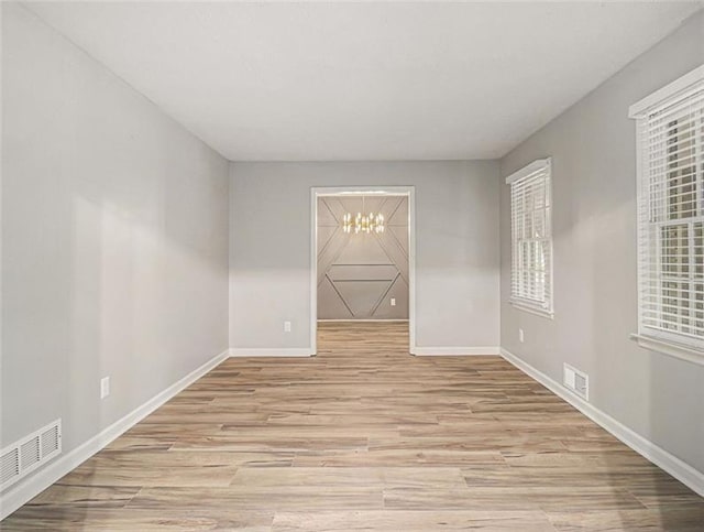 2544 Peyton Woods Trl SW, Atlanta, GA 30311 - unfurnished room with a chandelier, light wood finished floors, and baseboards