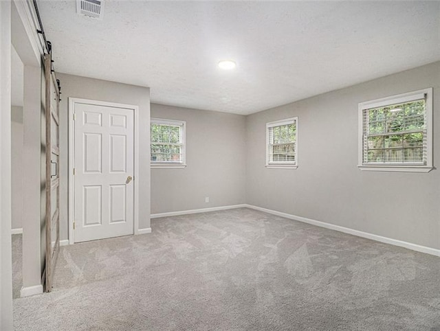 2544 Peyton Woods Trl SW, Atlanta, GA 30311 - unfurnished room featuring a barn door, carpet flooring, and baseboards