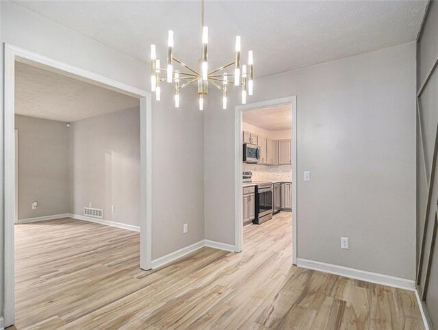 2544 Peyton Woods Trl SW, Atlanta, GA 30311 - spare room with a chandelier, light wood finished floors, and baseboards