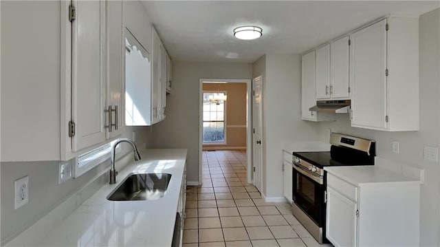 kitchen featuring white cabinets, under cabinet range hood, stainless steel electric range, and light tile patterned floors