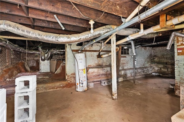 unfinished basement featuring brick wall and gas water heater