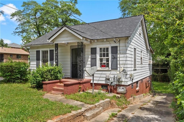 bungalow with a shingled roof