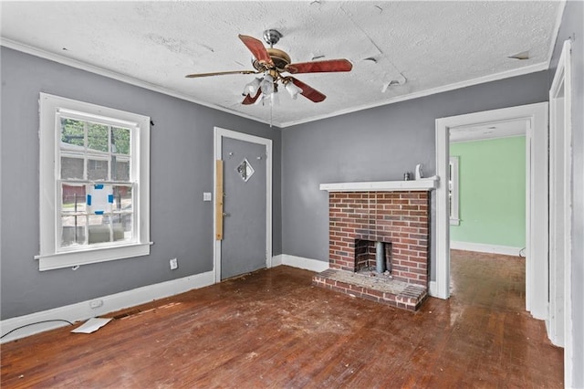 unfurnished living room with crown molding, ceiling fan, a brick fireplace, and wood finished floors