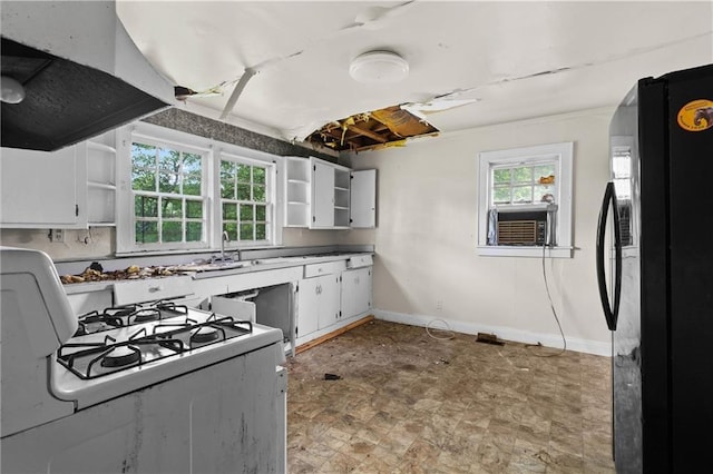 kitchen featuring open shelves, freestanding refrigerator, exhaust hood, and white gas range