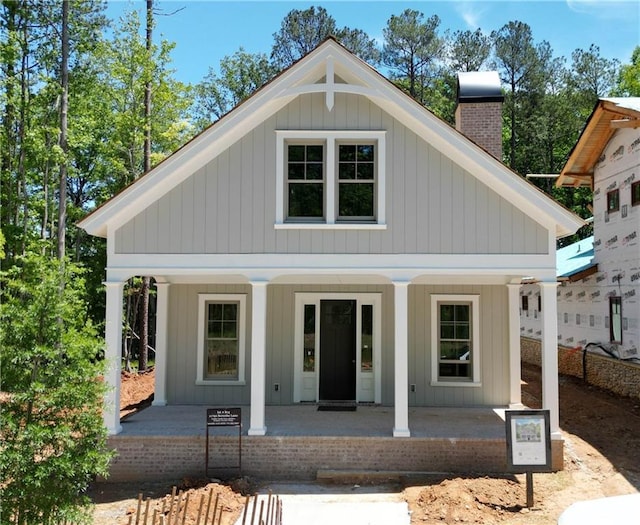 11792 Serenbe Ln, Chattahoochee Hills, GA 30268 - view of front of property with a porch and a chimney