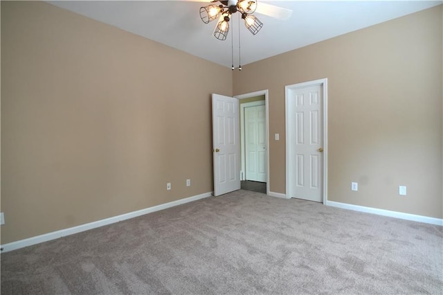 carpeted spare room featuring ceiling fan