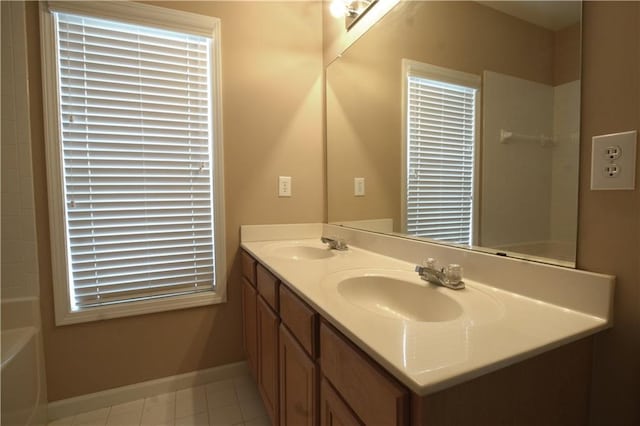 bathroom featuring a bathtub, vanity, and tile patterned flooring