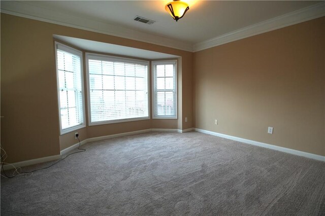 unfurnished room with carpet floors, plenty of natural light, and crown molding