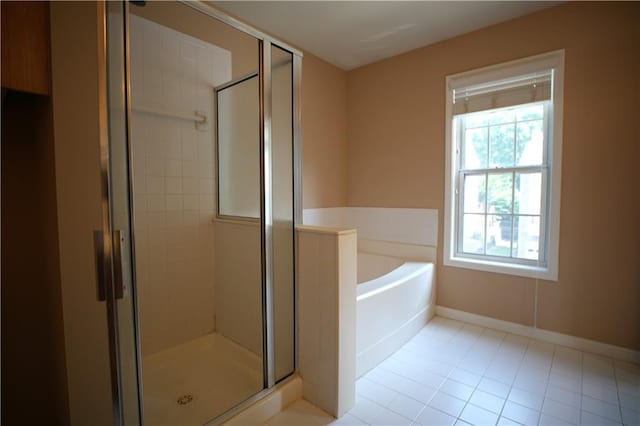 bathroom featuring tile patterned flooring and shower with separate bathtub