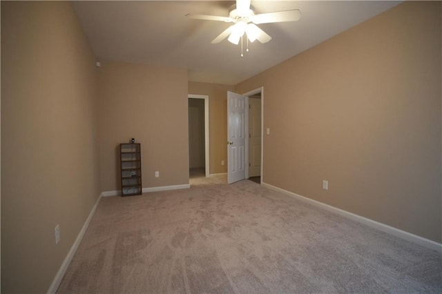 unfurnished room featuring ceiling fan and light colored carpet