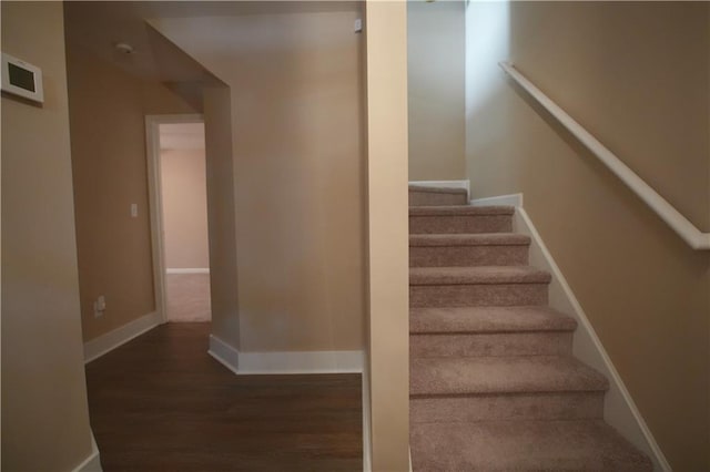 stairway with hardwood / wood-style floors