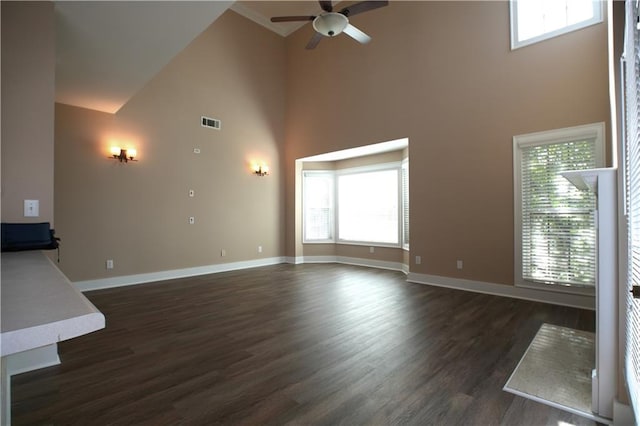 unfurnished living room featuring ceiling fan, dark hardwood / wood-style flooring, and high vaulted ceiling