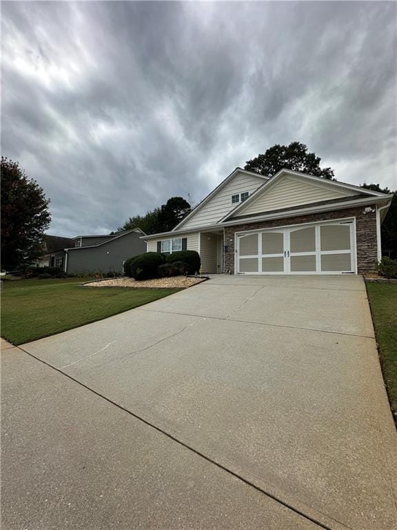 view of front of property with a garage and a front lawn