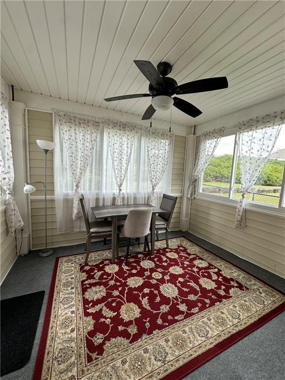 sunroom featuring wooden ceiling and ceiling fan