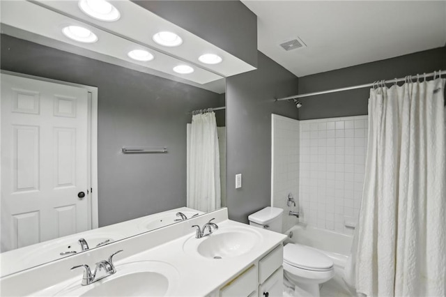 bathroom featuring a sink, visible vents, toilet, and shower / bath combo