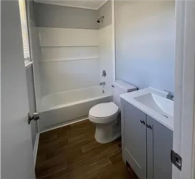 full bathroom with vanity, toilet, bathing tub / shower combination, and wood finished floors