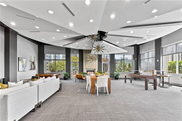 exercise room with a paneled ceiling and a wealth of natural light