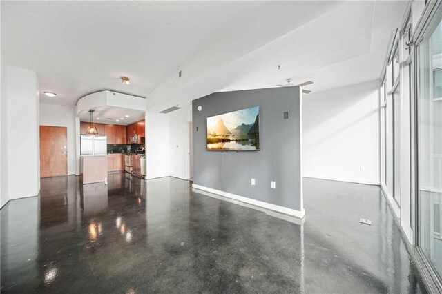 kitchen featuring a breakfast bar area, appliances with stainless steel finishes, tasteful backsplash, decorative light fixtures, and a kitchen island