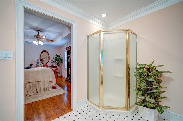 bathroom with wood-type flooring, crown molding, a shower with shower door, and ceiling fan