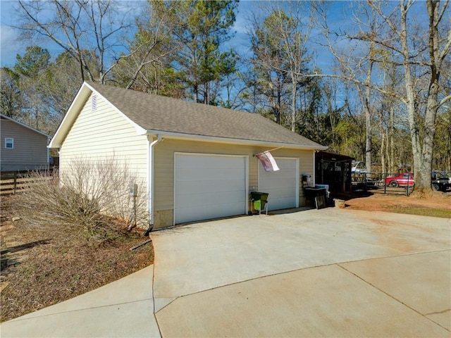 view of side of property featuring a garage and an outdoor structure