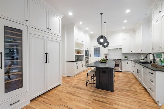 510 Northland Ridge Ct, Sandy Springs, GA 30342 - kitchen featuring appliances with stainless steel finishes, wine cooler, dark countertops, a center island, and white cabinets