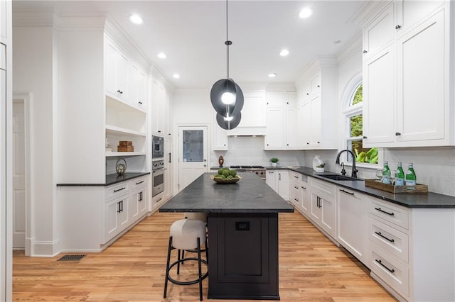 510 Northland Ridge Ct, Sandy Springs, GA 30342 - kitchen with stainless steel appliances, dark countertops, a center island, white cabinets, and recessed lighting