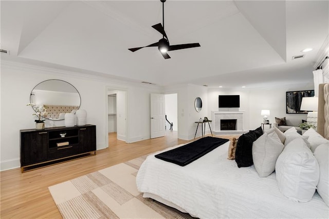 510 Northland Ridge Ct, Sandy Springs, GA 30342 - bedroom featuring light wood finished floors, recessed lighting, a tray ceiling, crown molding, and a fireplace