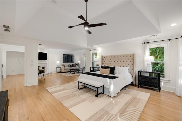 510 Northland Ridge Ct, Sandy Springs, GA 30342 - bedroom with light wood finished floors, a fireplace with raised hearth, ornamental molding, recessed lighting, and lofted ceiling