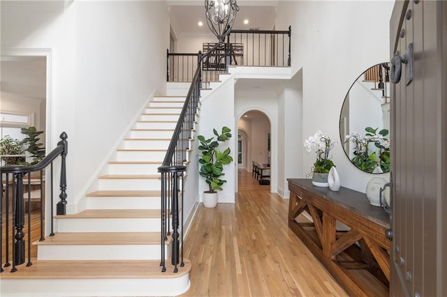 510 Northland Ridge Ct, Sandy Springs, GA 30342 - foyer entrance featuring arched walkways, stairway, a high ceiling, light wood-style flooring, and crown molding
